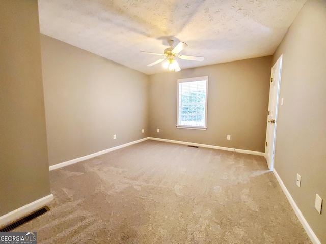 spare room with visible vents, baseboards, and ceiling fan
