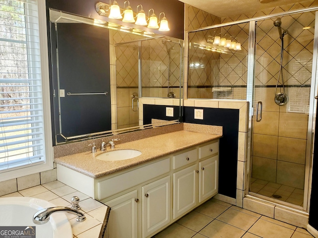 bathroom featuring vanity, tile patterned flooring, and a shower stall