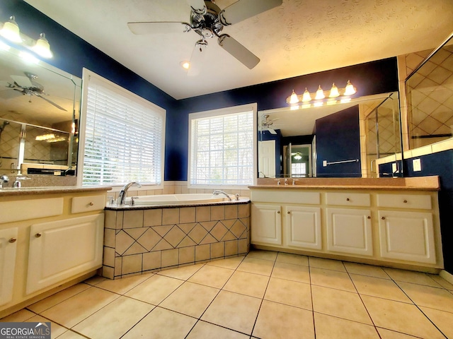 bathroom featuring a sink, a bath, ceiling fan, a tile shower, and tile patterned flooring