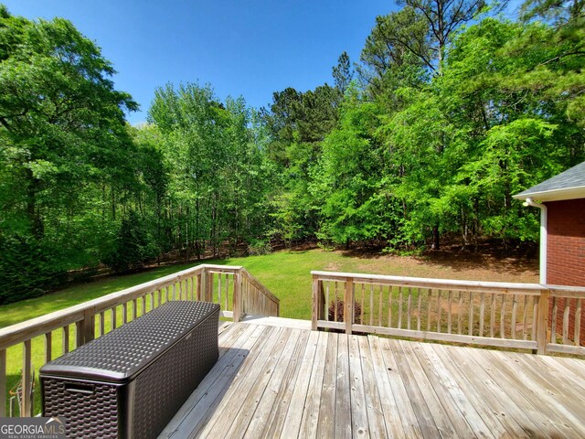 wooden deck with a lawn