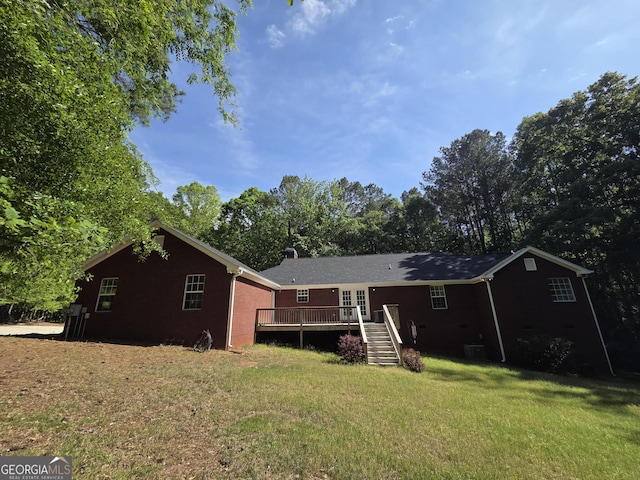 view of front of home featuring stairway, a front yard, central air condition unit, and a deck