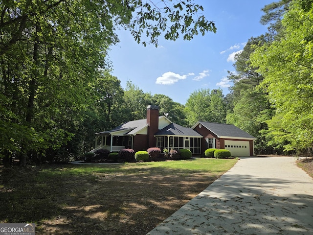 single story home with a garage, a front lawn, a chimney, and concrete driveway