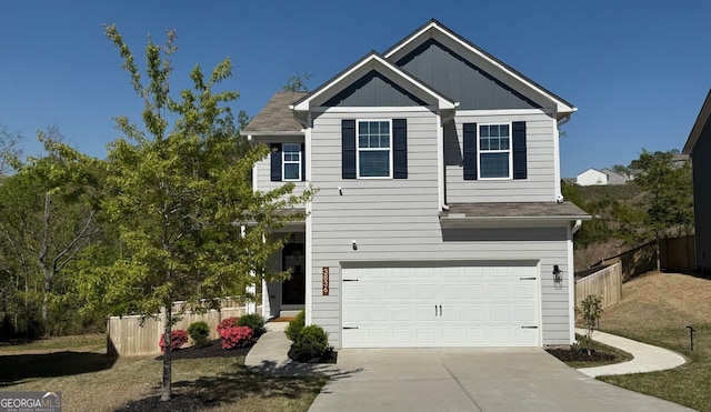 view of front of house featuring fence, a garage, driveway, and board and batten siding