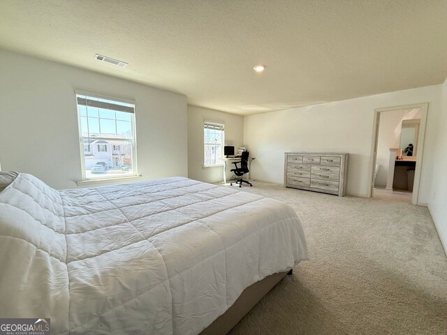 carpeted bedroom featuring a textured ceiling and recessed lighting