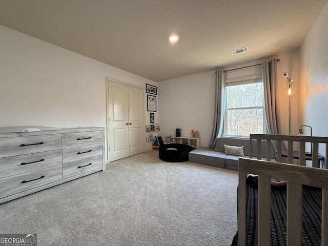 carpeted bedroom featuring a closet
