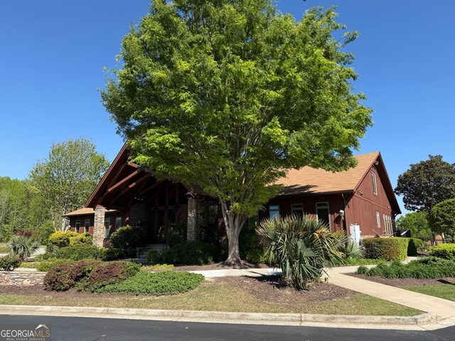 view of front of house featuring a garage, driveway, fence, and board and batten siding