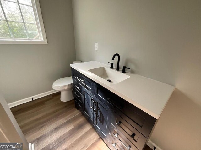 1350 Dogwood Rd, Woodville, GA 30669 - bathroom with toilet, wood finished floors, baseboards, and vanity