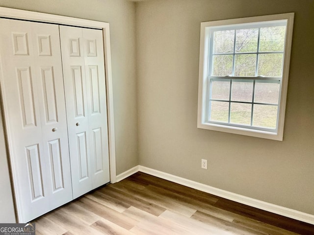 1350 Dogwood Rd, Woodville, GA 30669 - unfurnished bedroom with a closet, baseboards, and wood finished floors