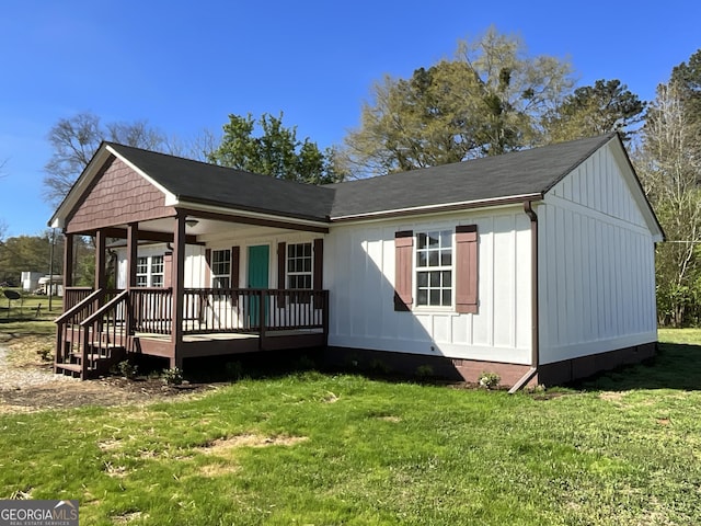 1350 Dogwood Rd, Woodville, GA 30669 - view of front of house with board and batten siding and a front lawn
