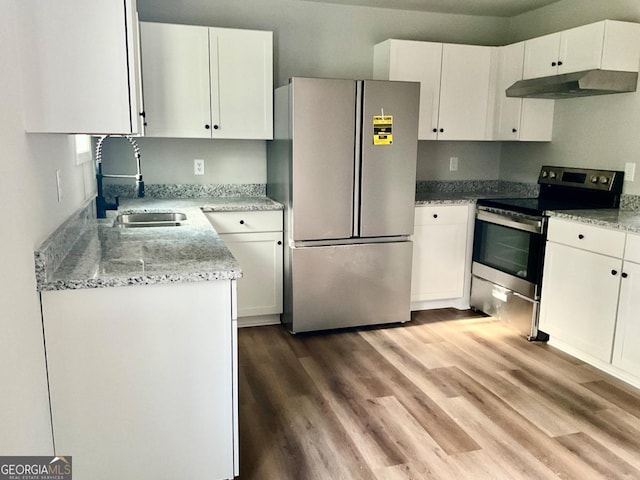 1350 Dogwood Rd, Woodville, GA 30669 - kitchen with white cabinets, under cabinet range hood, a sink, and stainless steel appliances