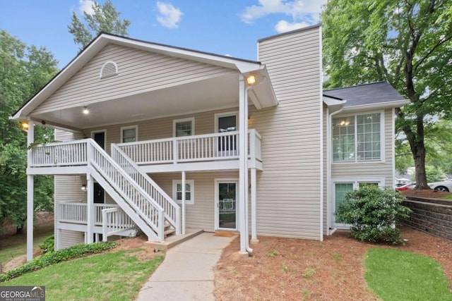 exterior space featuring stairway, a chimney, and a deck