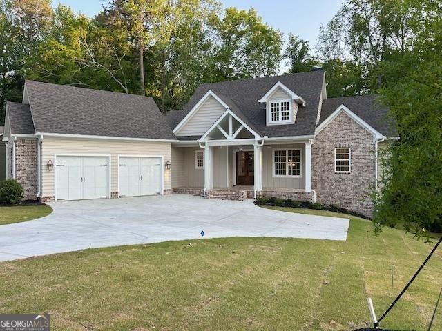 7 Fontaine Dr, Newnan, GA 30263 - craftsman inspired home with an attached garage, a porch, a front yard, and concrete driveway