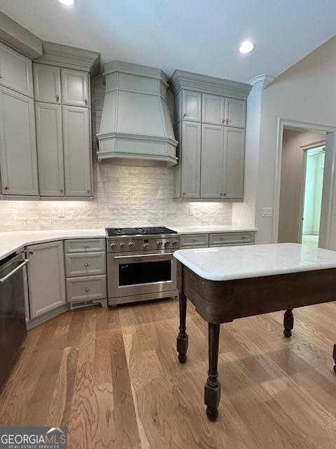 7 Fontaine Dr, Newnan, GA 30263 - kitchen with appliances with stainless steel finishes, custom exhaust hood, gray cabinets, tasteful backsplash, and recessed lighting