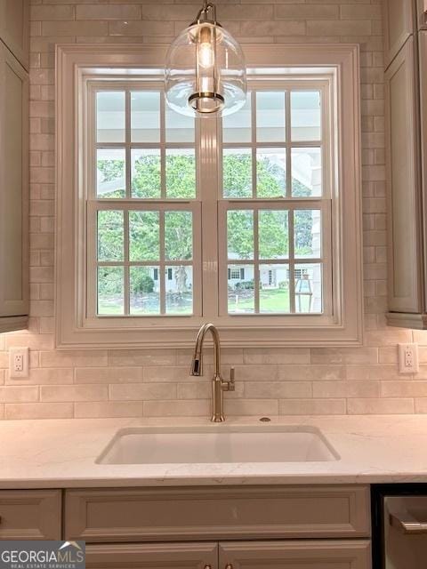 7 Fontaine Dr, Newnan, GA 30263 - kitchen view of a sink, decorative backsplash, stainless steel dishwasher, and light stone countertops