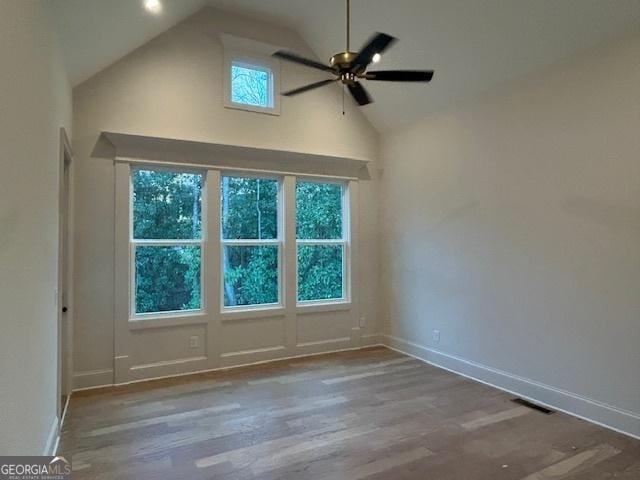 7 Fontaine Dr, Newnan, GA 30263 - unfurnished room with high vaulted ceiling, baseboards, a ceiling fan, and wood finished floors