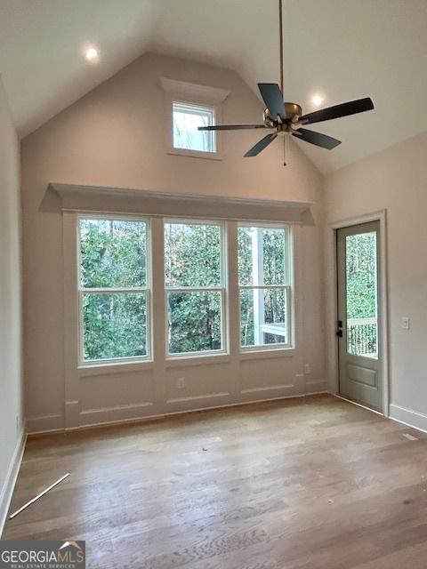 7 Fontaine Dr, Newnan, GA 30263 - unfurnished living room featuring a ceiling fan, wood finished floors, high vaulted ceiling, and baseboards