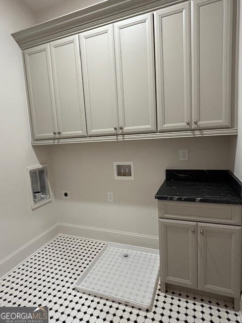 7 Fontaine Dr, Newnan, GA 30263 - laundry room featuring cabinet space, hookup for a washing machine, electric dryer hookup, and baseboards