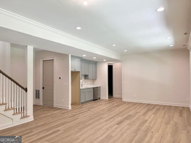 7 Fontaine Dr, Newnan, GA 30263 - unfurnished living room featuring crown molding, light wood finished floors, baseboards, stairs, and recessed lighting