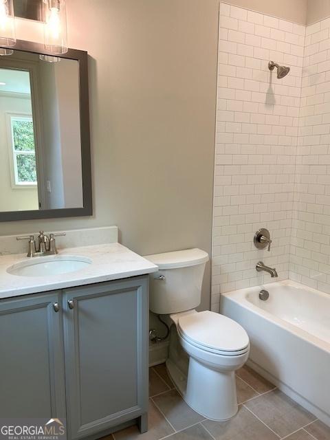 7 Fontaine Dr, Newnan, GA 30263 - bathroom with toilet, tile patterned floors, vanity, and shower / washtub combination