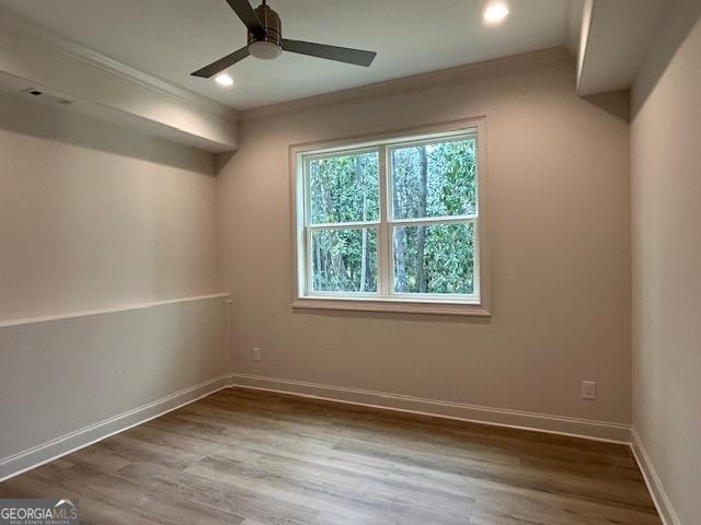 7 Fontaine Dr, Newnan, GA 30263 - empty room featuring ceiling fan, wood finished floors, baseboards, recessed lighting, and crown molding