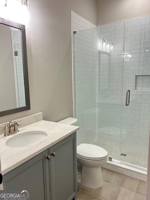 7 Fontaine Dr, Newnan, GA 30263 - bathroom featuring a stall shower, toilet, vanity, and tile patterned flooring