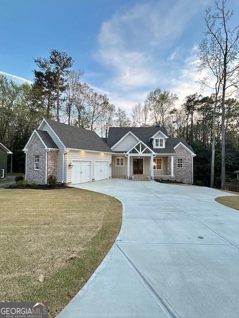 7 Fontaine Dr, Newnan, GA 30263 - view of front of property featuring a garage, driveway, stone siding, and a front lawn