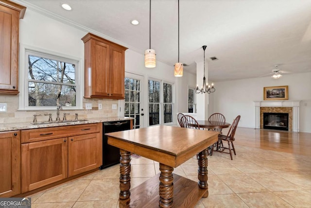 2002 Stonewick Ct, Lawrenceville, GA 30043 - kitchen featuring black dishwasher, brown cabinetry, a glass covered fireplace, tasteful backsplash, and light tile patterned floors