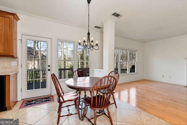2002 Stonewick Ct, Lawrenceville, GA 30043 - dining room with a chandelier, ornamental molding, and light wood-style flooring