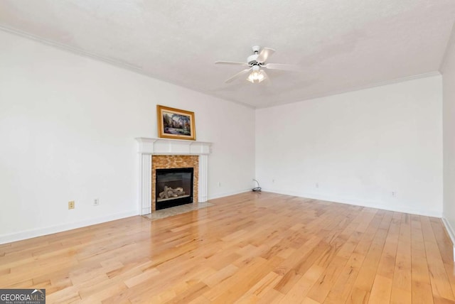 2002 Stonewick Ct, Lawrenceville, GA 30043 - unfurnished living room featuring a ceiling fan, a tile fireplace, wood finished floors, and ornamental molding