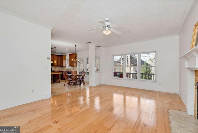 2002 Stonewick Ct, Lawrenceville, GA 30043 - living room with a fireplace, ceiling fan, light wood-type flooring, and ornamental molding