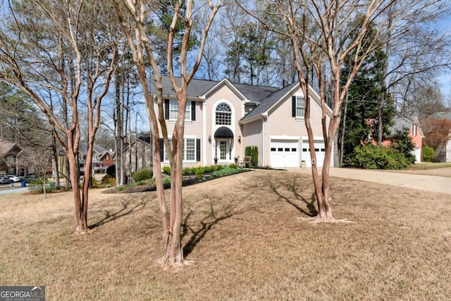 2002 Stonewick Ct, Lawrenceville, GA 30043 - view of front of home with stucco siding, concrete driveway, an attached garage, and a front yard