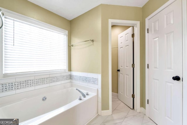 2002 Stonewick Ct, Lawrenceville, GA 30043 - full bathroom with a garden tub and marble look tiles