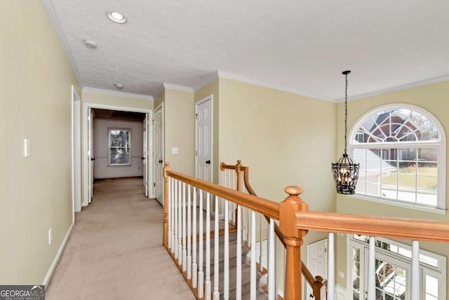 2002 Stonewick Ct, Lawrenceville, GA 30043 - hall with an upstairs landing, light carpet, a chandelier, and ornamental molding