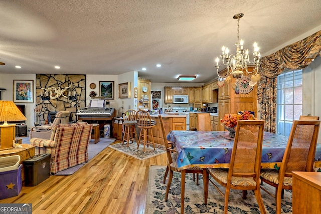 1327 Pinnacle Dr, Clayton, GA 30525 - dining room featuring recessed lighting, a chandelier, a textured ceiling, and light wood-type flooring