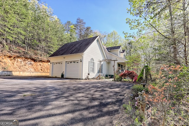 1327 Pinnacle Dr, Clayton, GA 30525 - view of side of property featuring an attached garage and driveway