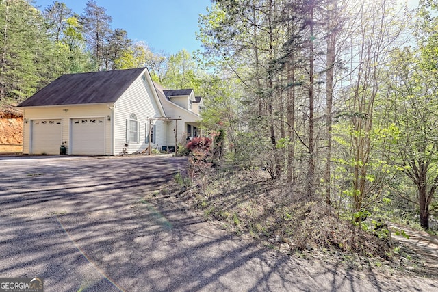 1327 Pinnacle Dr, Clayton, GA 30525 - view of home's exterior featuring an attached garage and aphalt driveway