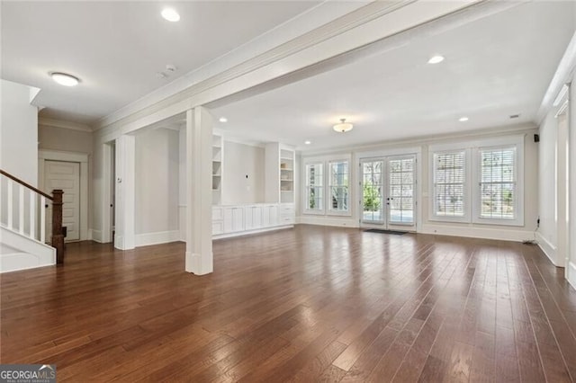 unfurnished living room featuring ornamental molding, wood finished floors, stairway, baseboards, and recessed lighting