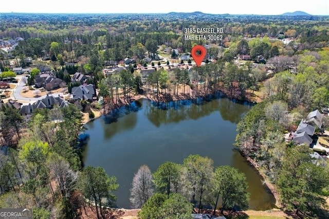 aerial view of a heavily wooded area and a nearby body of water