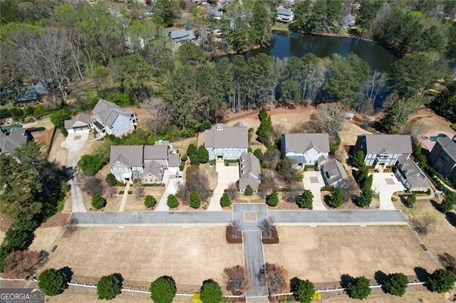 view of property location featuring a nearby body of water and nearby suburban area