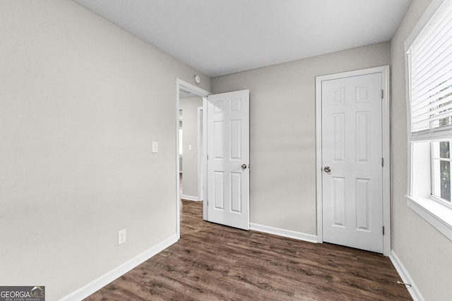 109 White Ave, Hogansville, GA 30230 - unfurnished bedroom featuring baseboards and dark wood-style floors