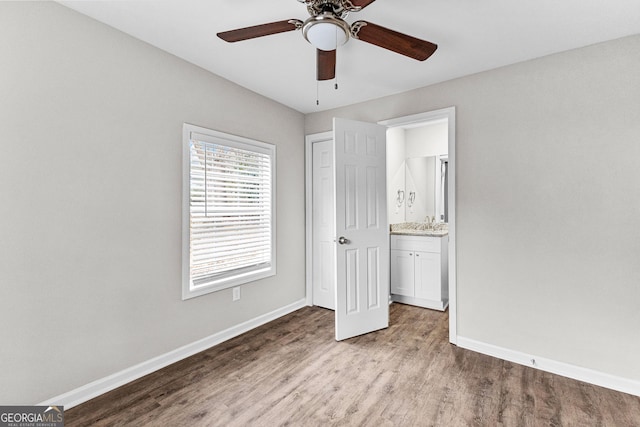 109 White Ave, Hogansville, GA 30230 - unfurnished bedroom with a sink, baseboards, ensuite bath, and wood finished floors