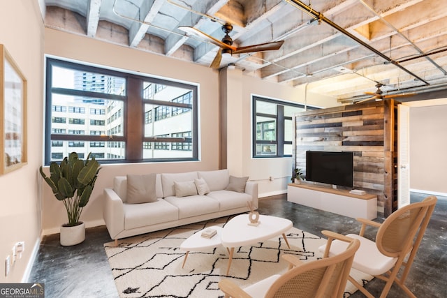 living area featuring baseboards and concrete flooring