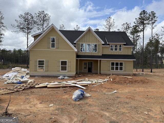 rear view of house featuring board and batten siding