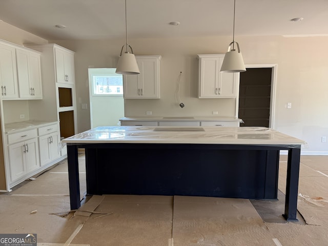 kitchen with a center island, pendant lighting, and white cabinets