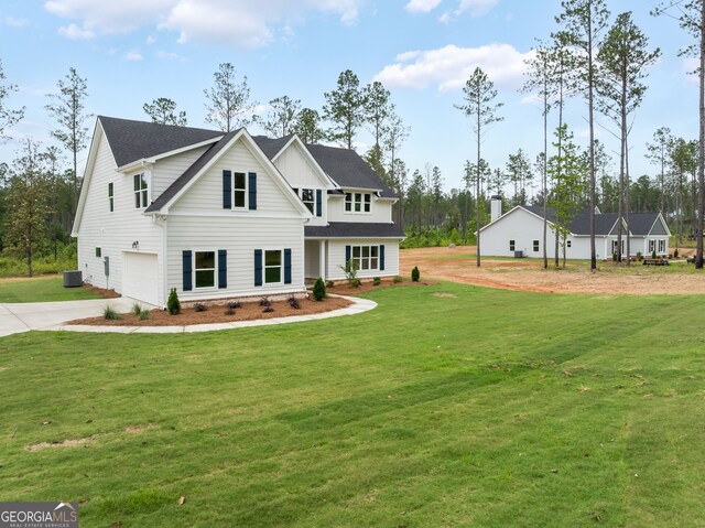 561 Jugtown Rd, Meansville, GA 30256 - view of front of house with concrete driveway, a garage, a front yard, and central AC unit