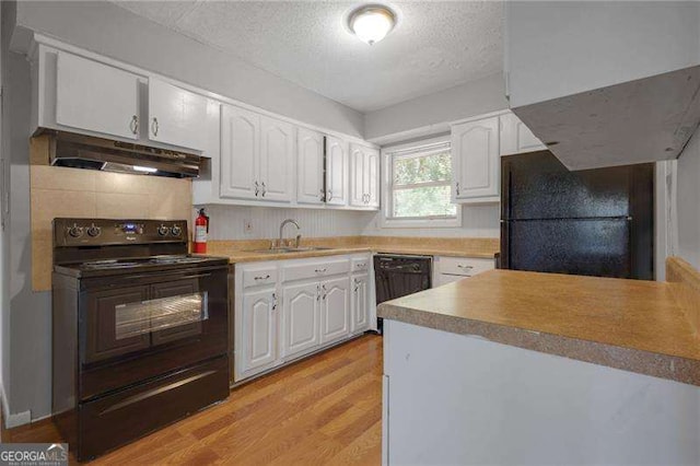 2522 Brentwood Ct, Decatur, GA 30032 - kitchen with white cabinetry, black appliances, under cabinet range hood, and a sink