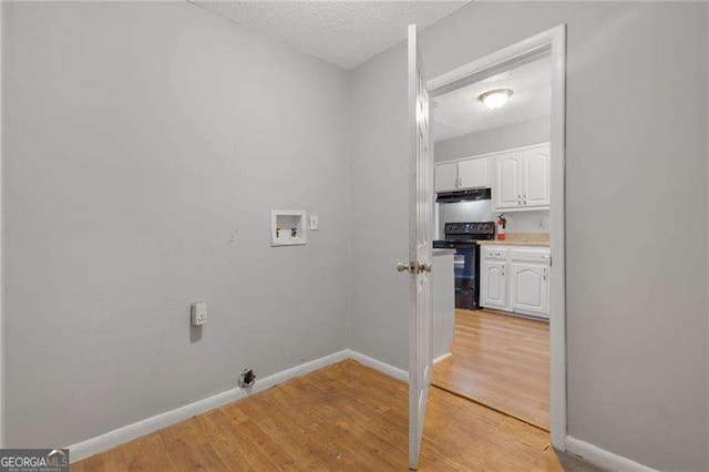 2522 Brentwood Ct, Decatur, GA 30032 - laundry area with a textured ceiling, light wood-style floors, baseboards, hookup for a washing machine, and laundry area