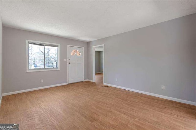 2522 Brentwood Ct, Decatur, GA 30032 - interior space with visible vents, baseboards, light wood finished floors, and a textured ceiling