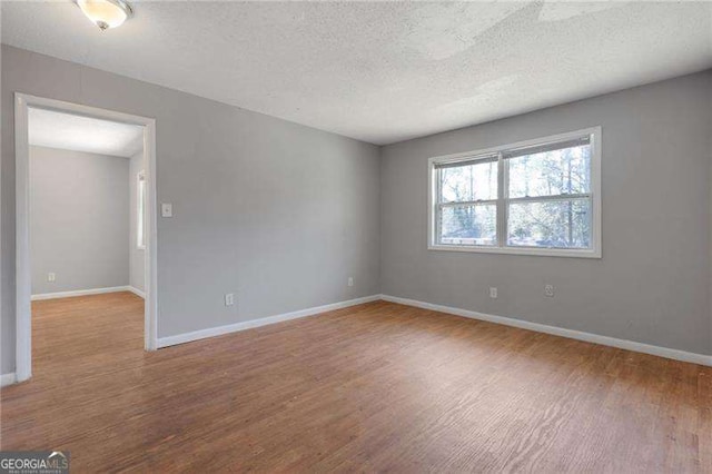 2522 Brentwood Ct, Decatur, GA 30032 - empty room with a textured ceiling, baseboards, and wood finished floors
