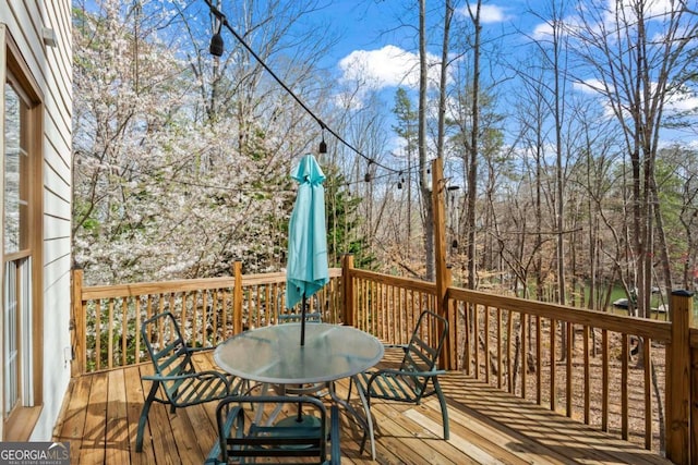 wooden deck with outdoor dining space